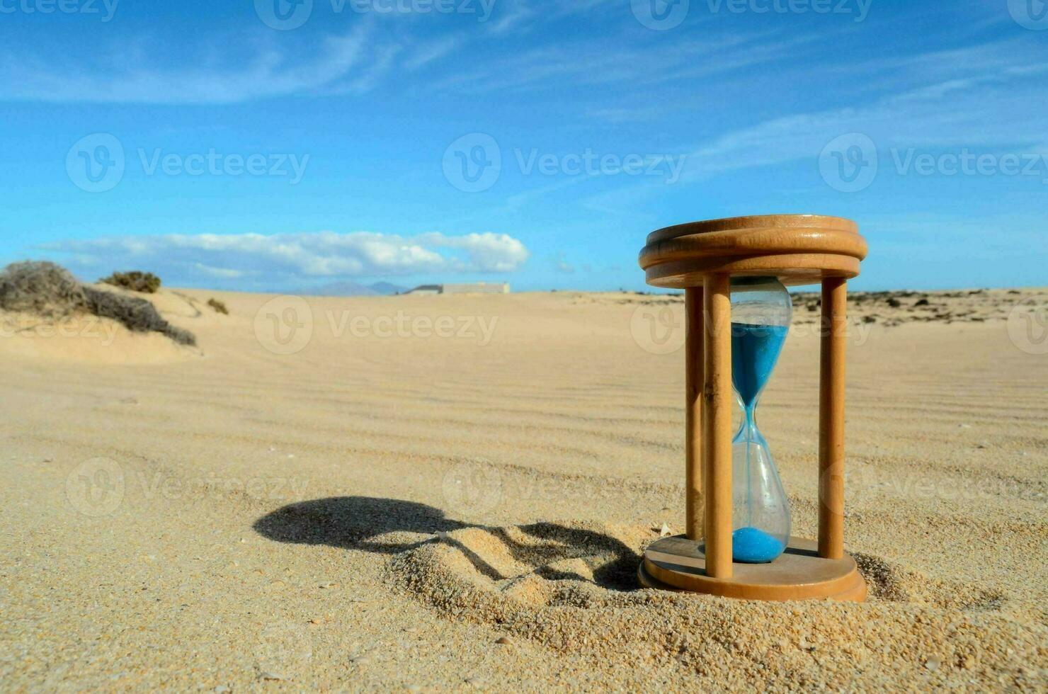 A hourglass in the sand photo