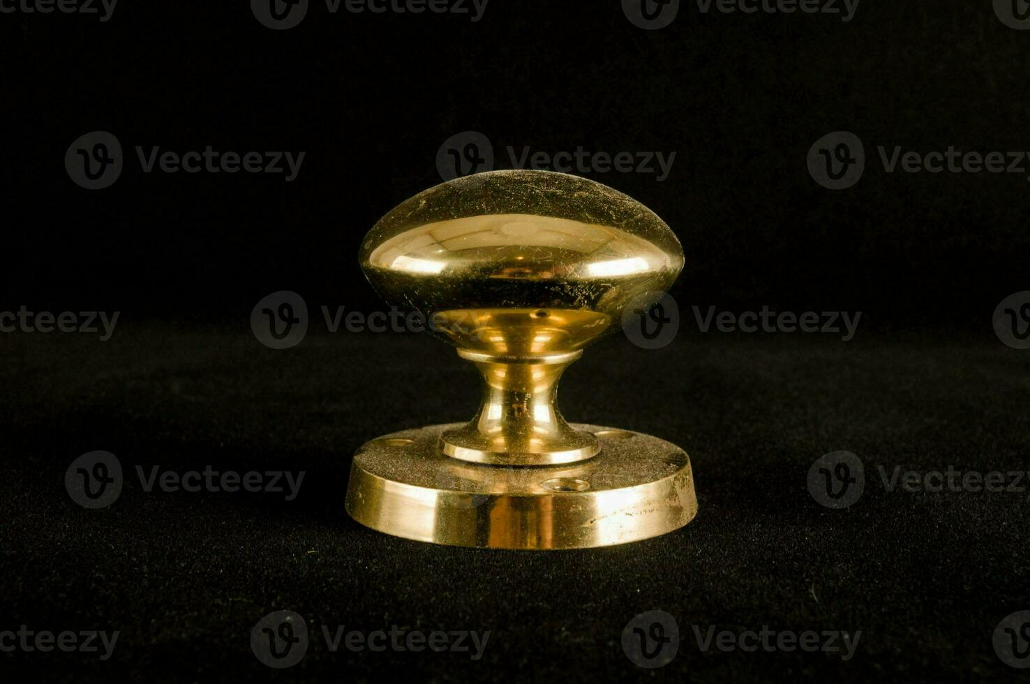 a brass knob on a black background photo