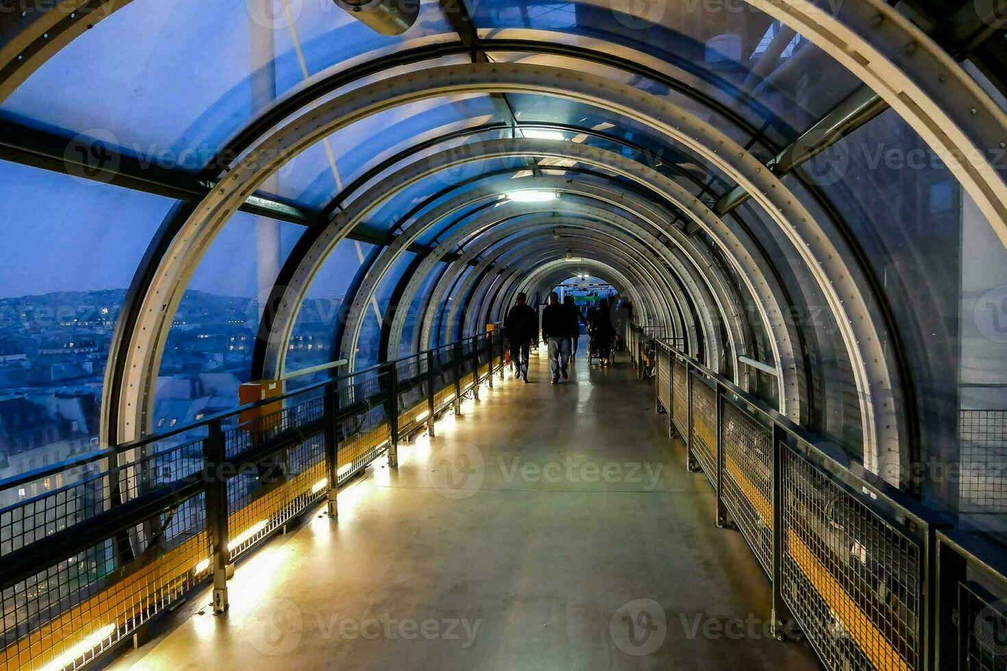 a tunnel with people walking on it photo