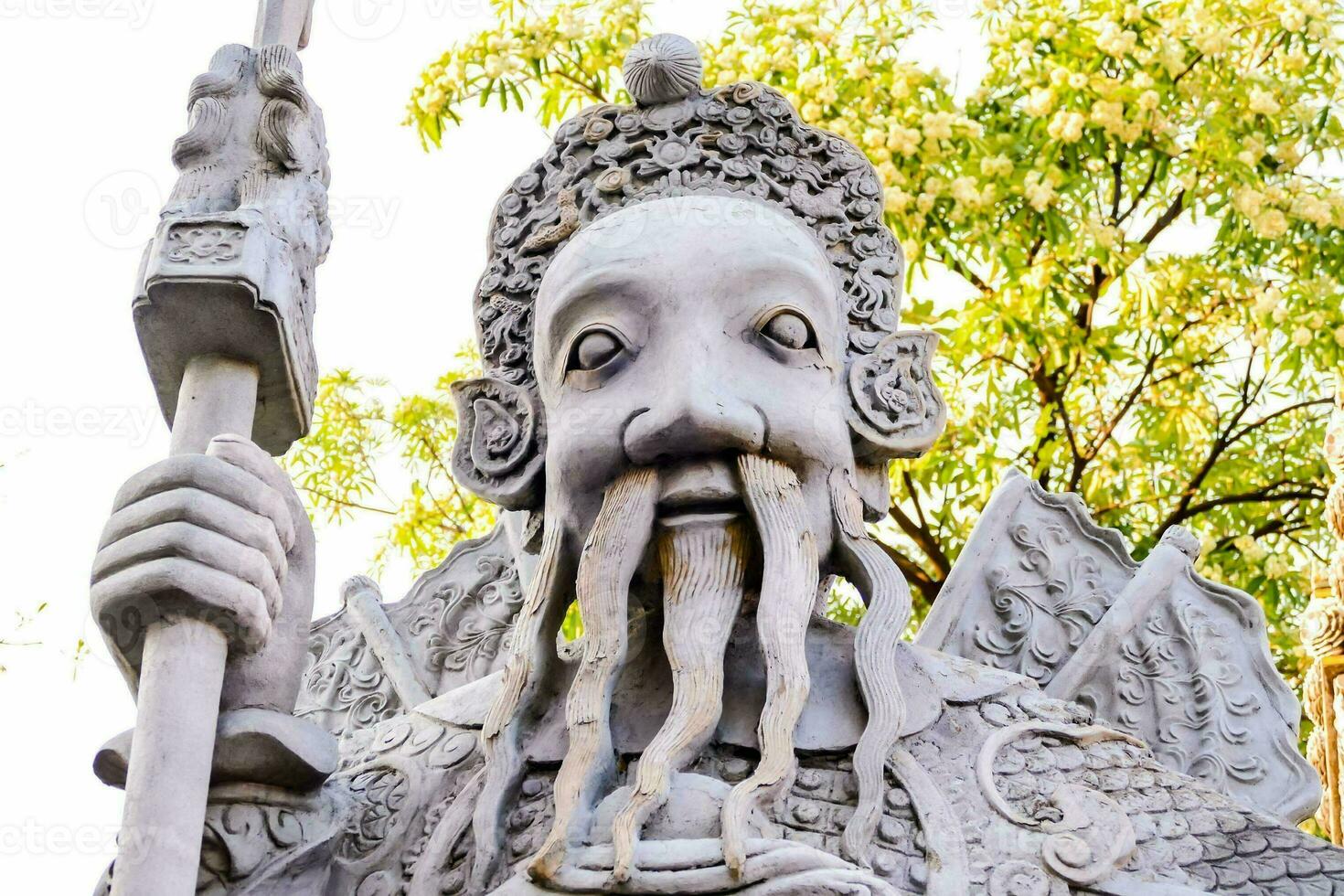 a statue of a man with a long beard and a staff photo