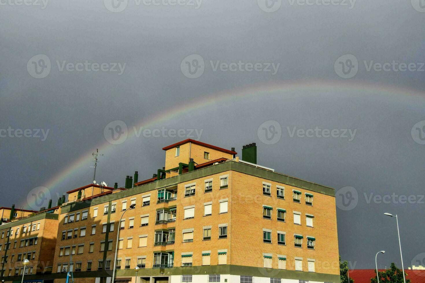 a rainbow appears over a building photo