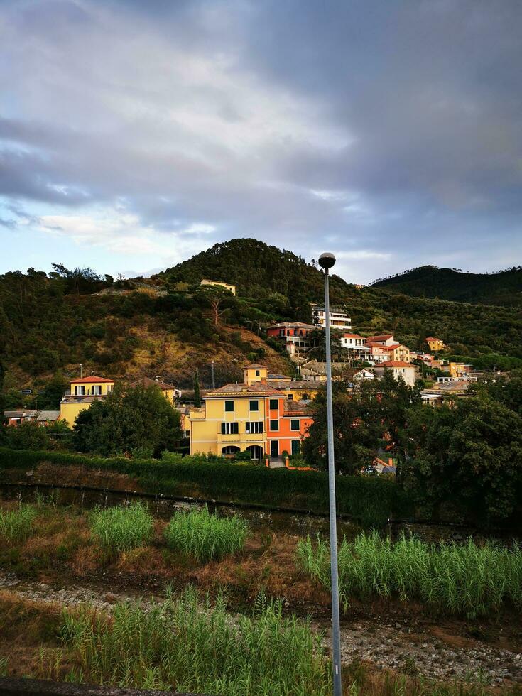 Photo of a street sign against a scenic backdrop of rolling hills