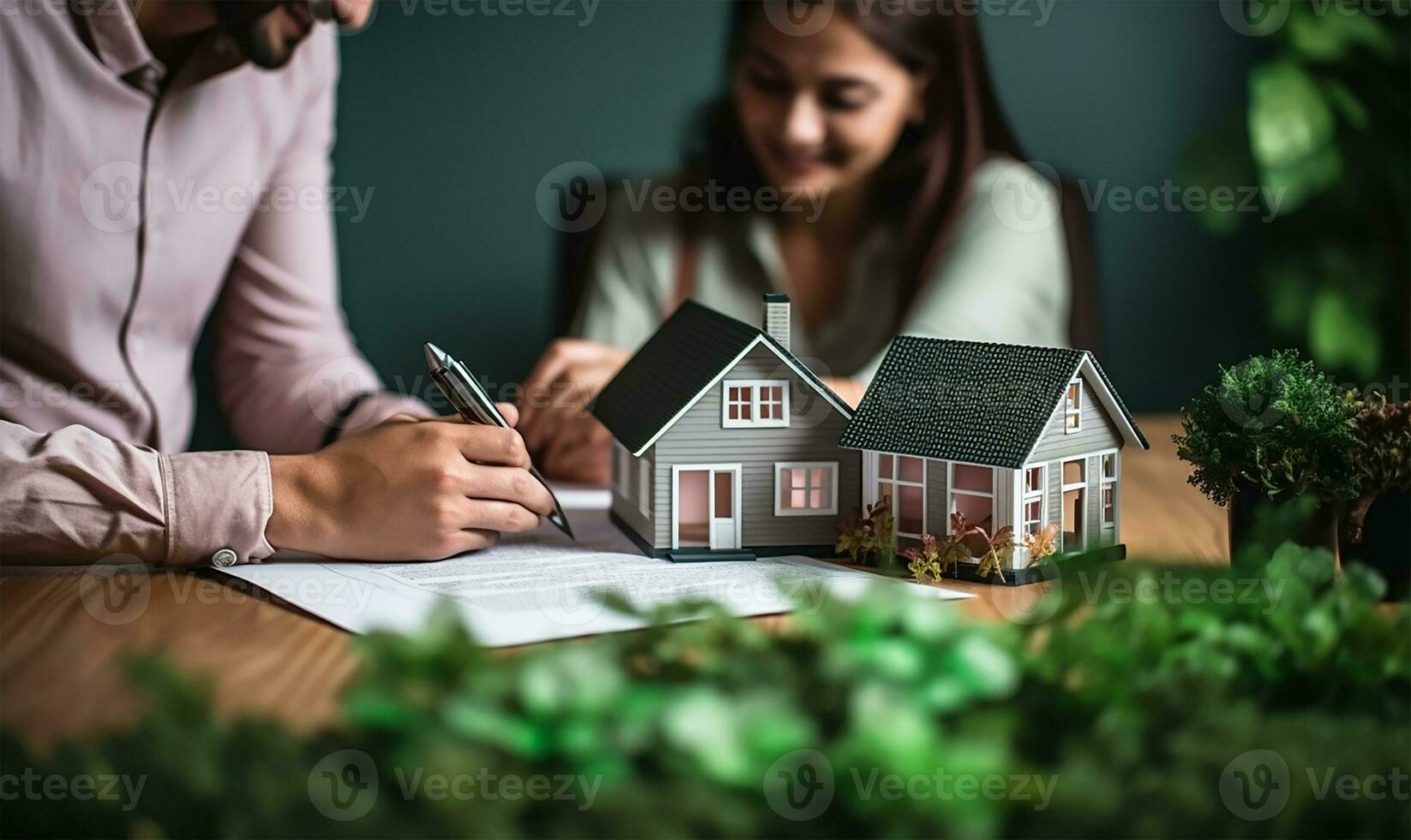 Real estate agent signing a mortgage agreement with a happy young couple with a close-up of a miniature house in the foreground. AI Generated photo