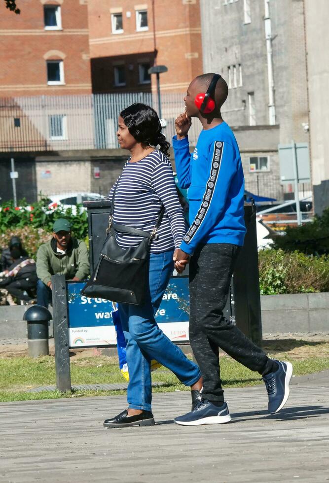 People are Walking at Main Shopping Center of Downtown City Centre of Luton City, England Great Britain UK. Image Captured on June 2nd, 2023 photo
