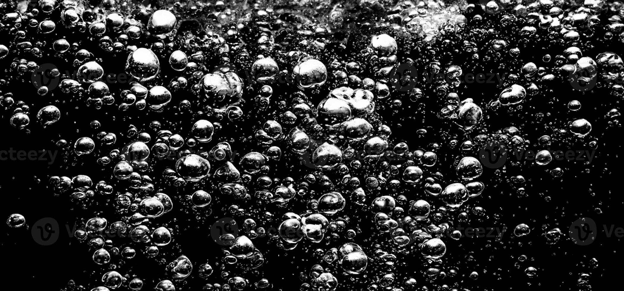 AI Generative Soda water bubbles splashing underwater against black background. photo