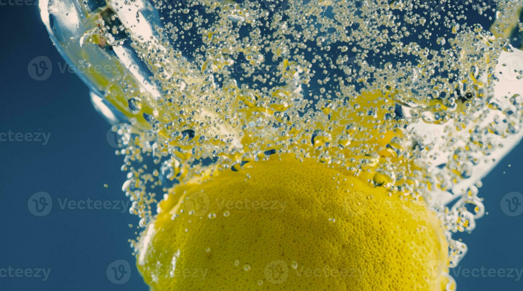 Underwater lemon slice in soda water or lemonade with bubbles. photo