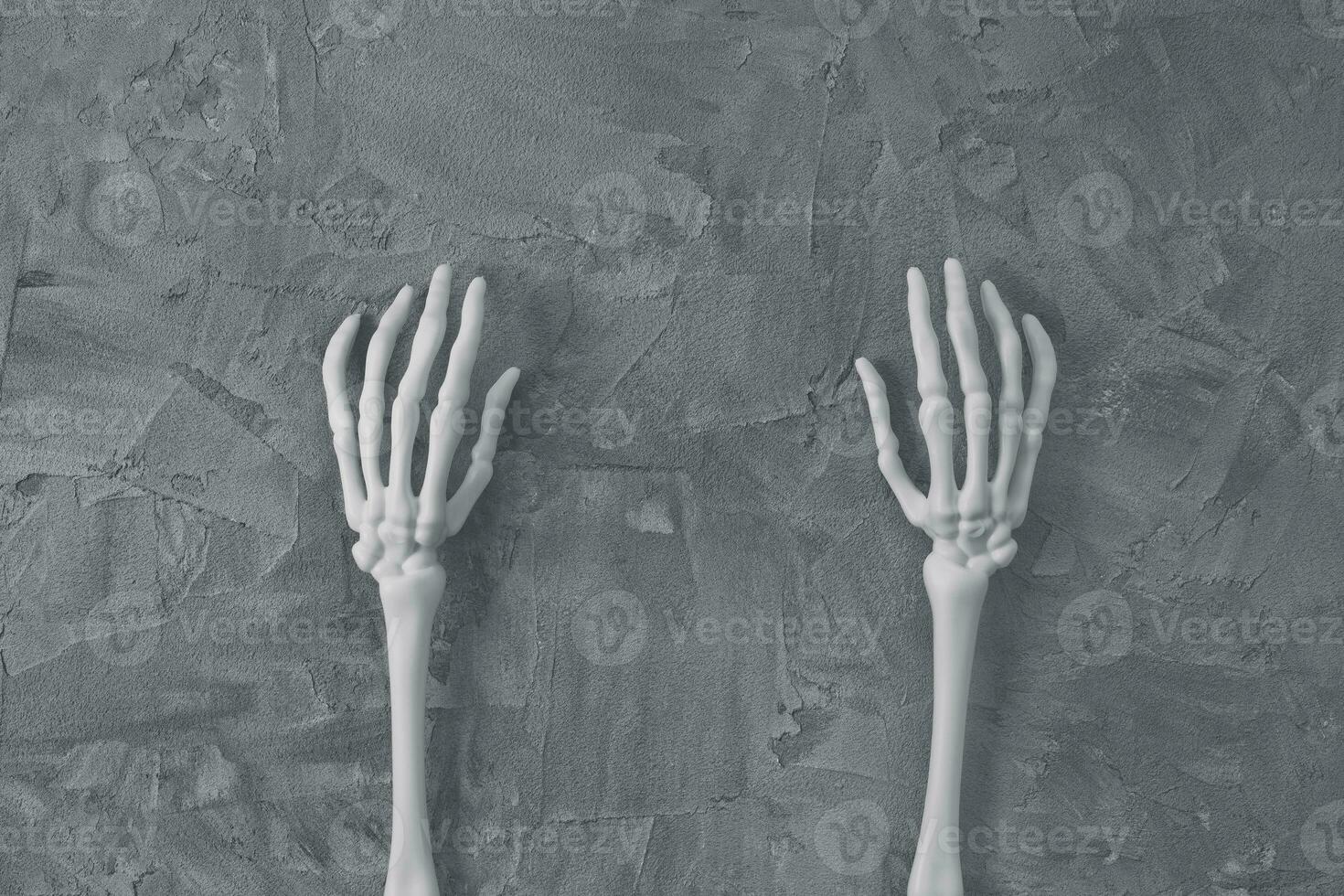 Mystery Halloween flat lay with white monster skeleton hands on dark gray background. Happy Halloween banner mockup. Top view, copy space photo