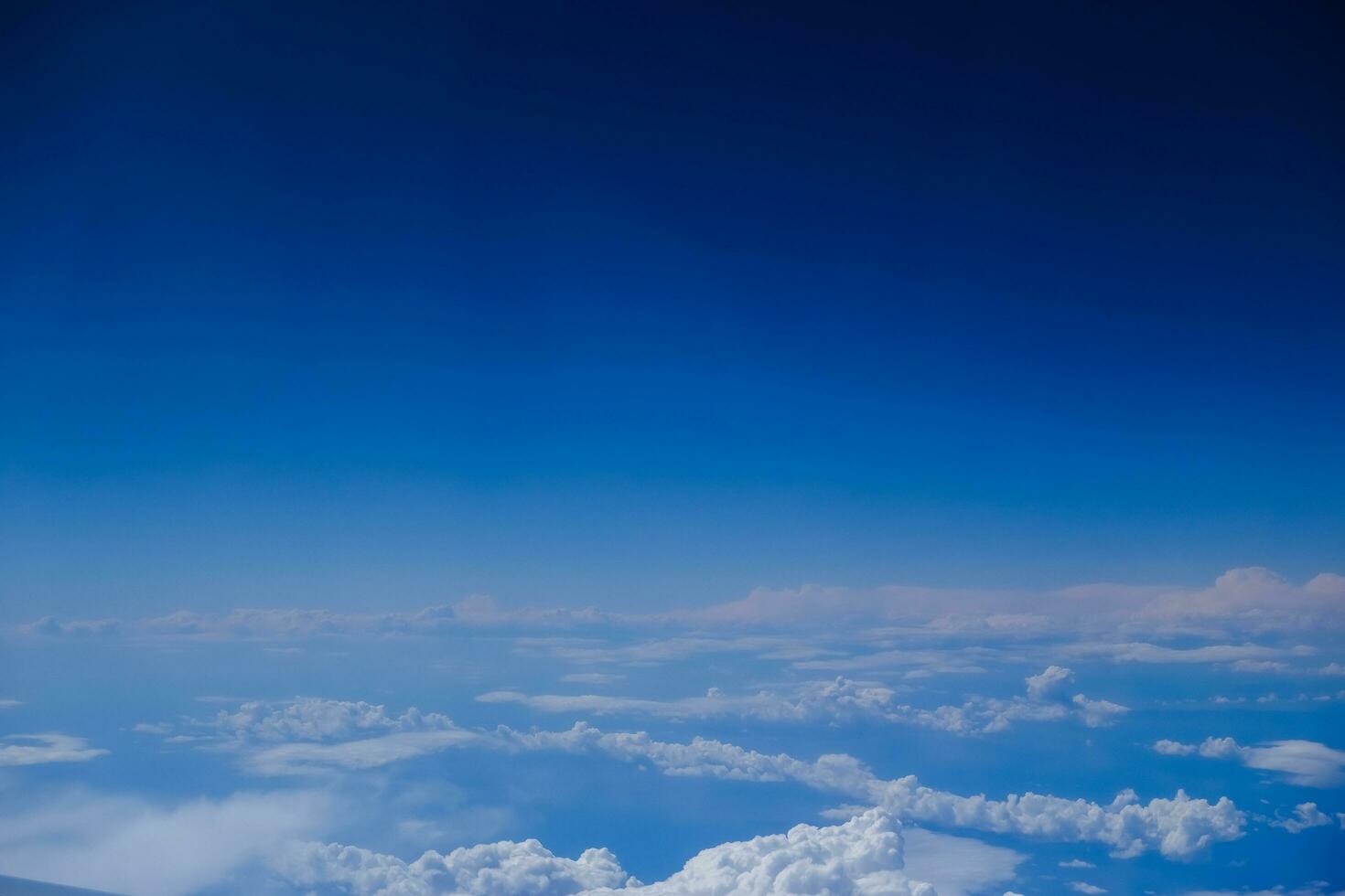 white clouds under a deep blue sky during a flight to egypt photo