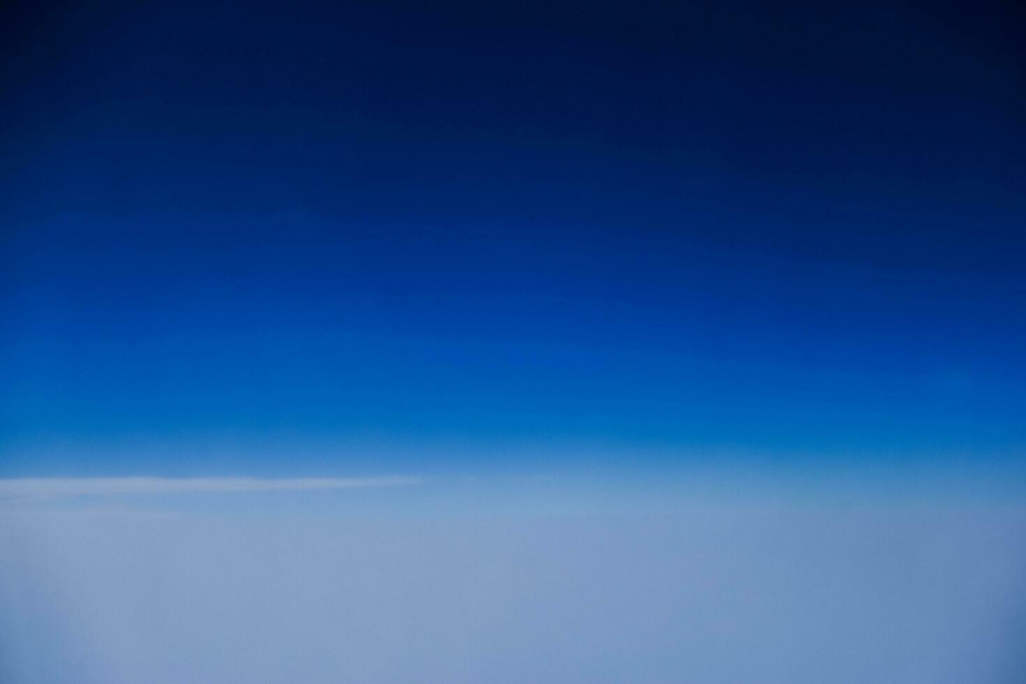 white fog under a very deep blue sky during a flight into the vacation photo