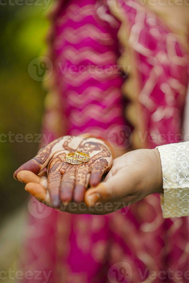 An Indian bride and groom their Shows Engagement Rings during a Hindu wedding ritual photo