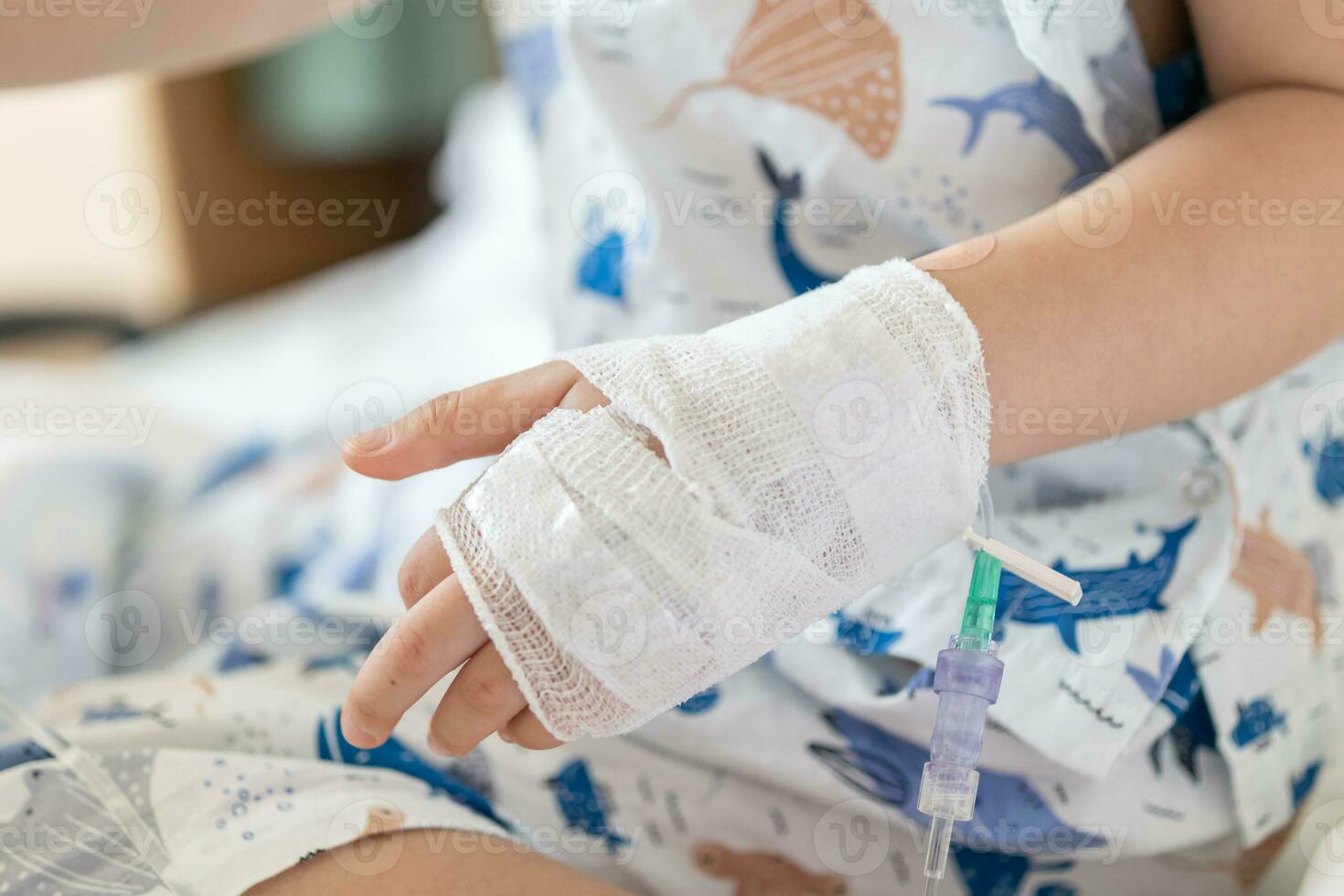 Close up child hand with saline IV solution in hospital photo