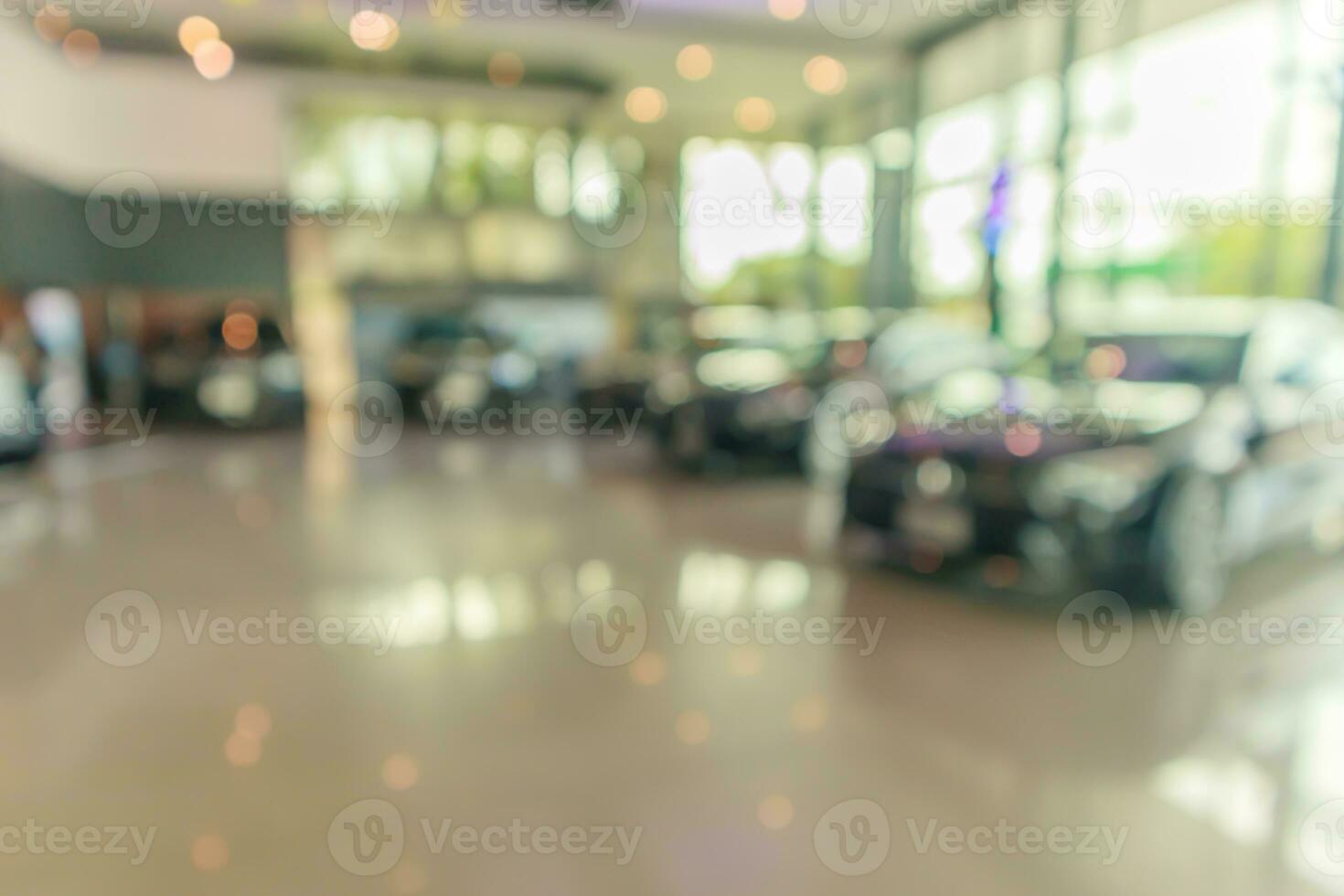 coches nuevos en el interior de la sala de exposición fondo abstracto borroso foto