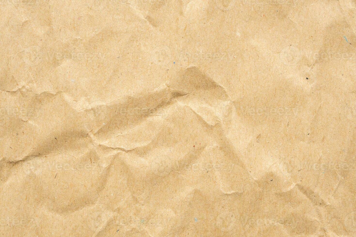 Abstract crumpled and creased recycle brown paper texture background photo