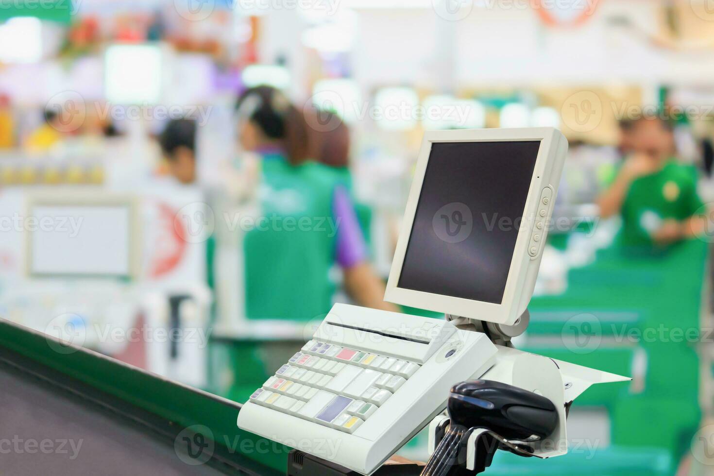 Empty cashier checkout desk with terminal in supermarket photo