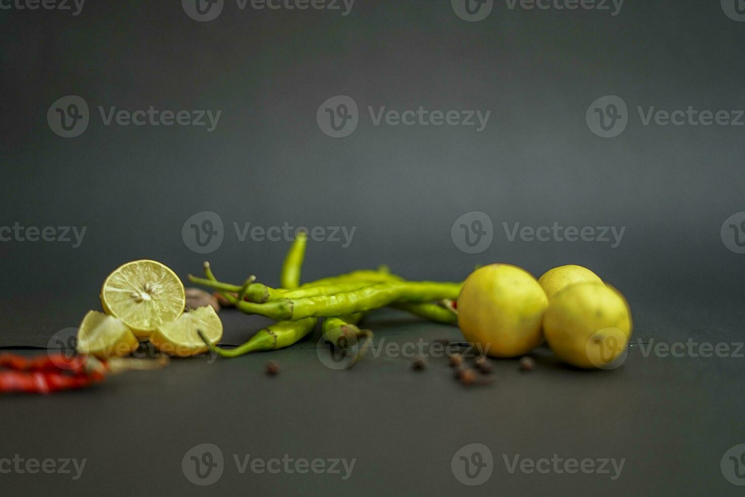 Red Chilli and lemon with black background photo