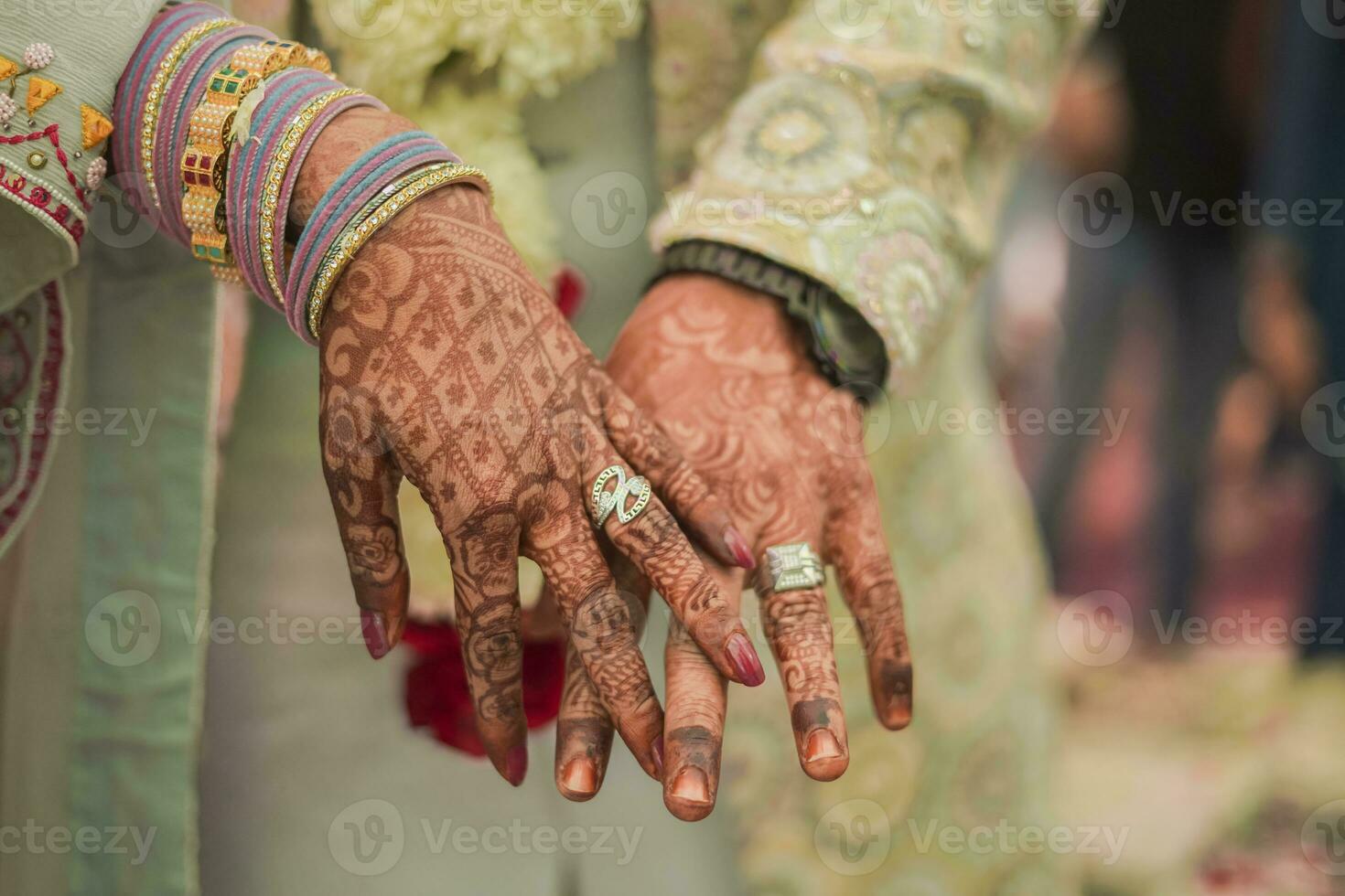 Indian groom and bride hand in hand showing ring photo
