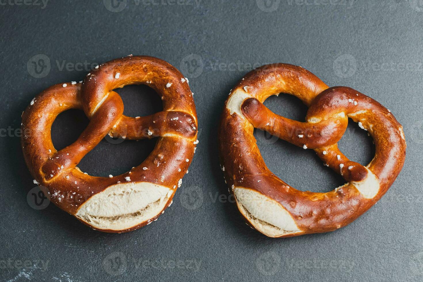 Two traditional soft Octoberfest pretzels on black background photo