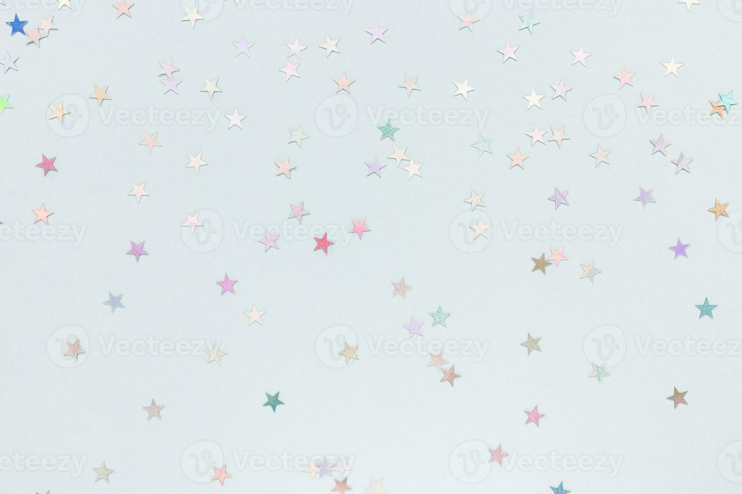 Trendy silver foil confetti stars on blue background. Festive abstract background. Birthday party, New Year, Christmas celebration, holidays, winter and dreams concept photo