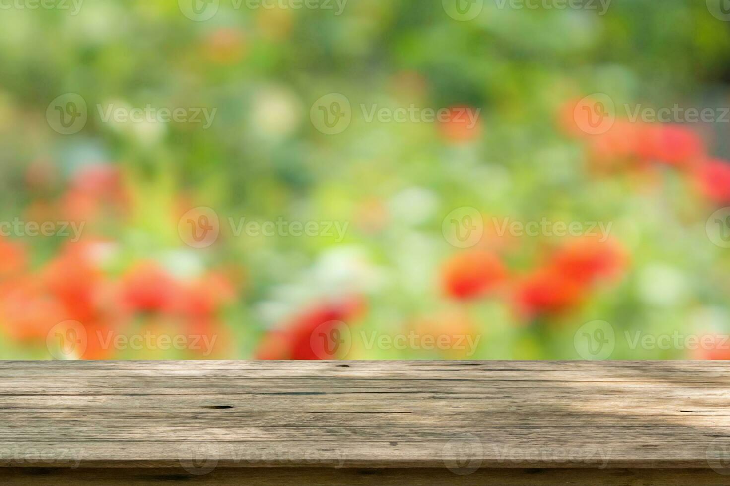 Empty wood table top with blur rose garden background for product display photo