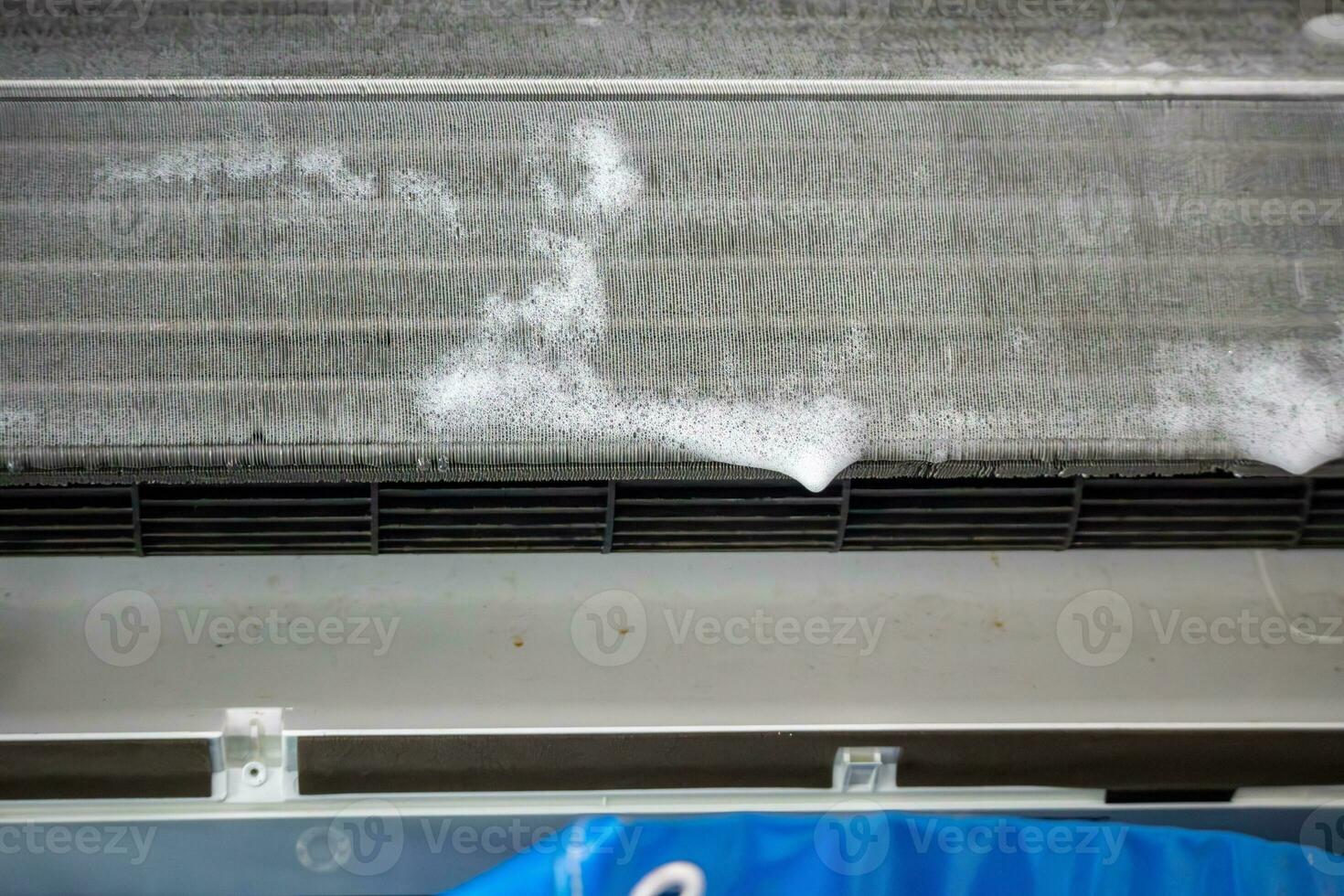 air conditioner cleaning with spray foam cleaner photo