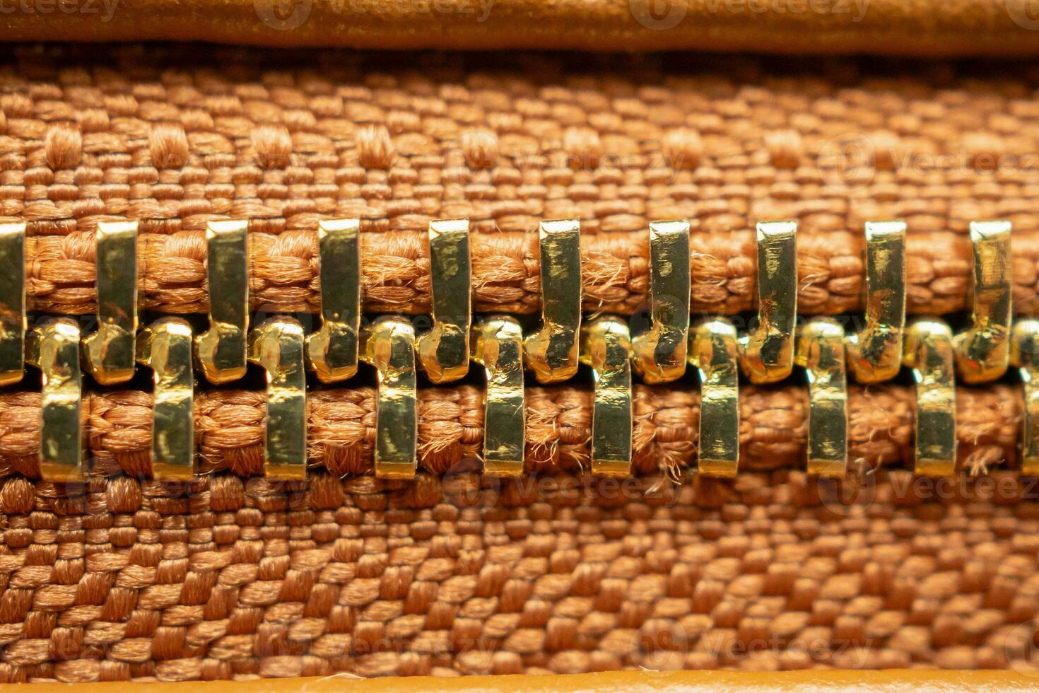 close up of zipper on brown leather bag photo