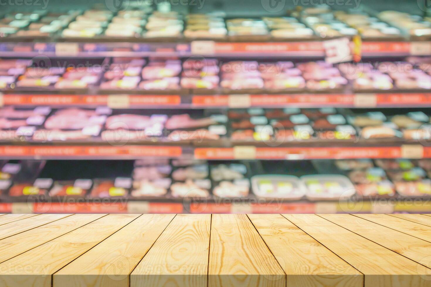 Empty wood table top with blur meat shelves in supermarket background for product display photo