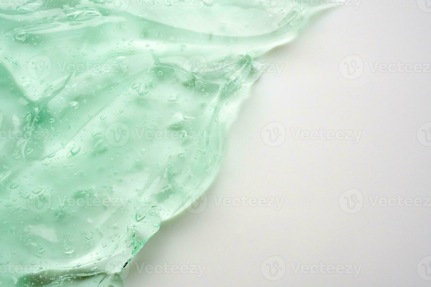 Transparent clear green liquid serum gel cosmetic texture background photo