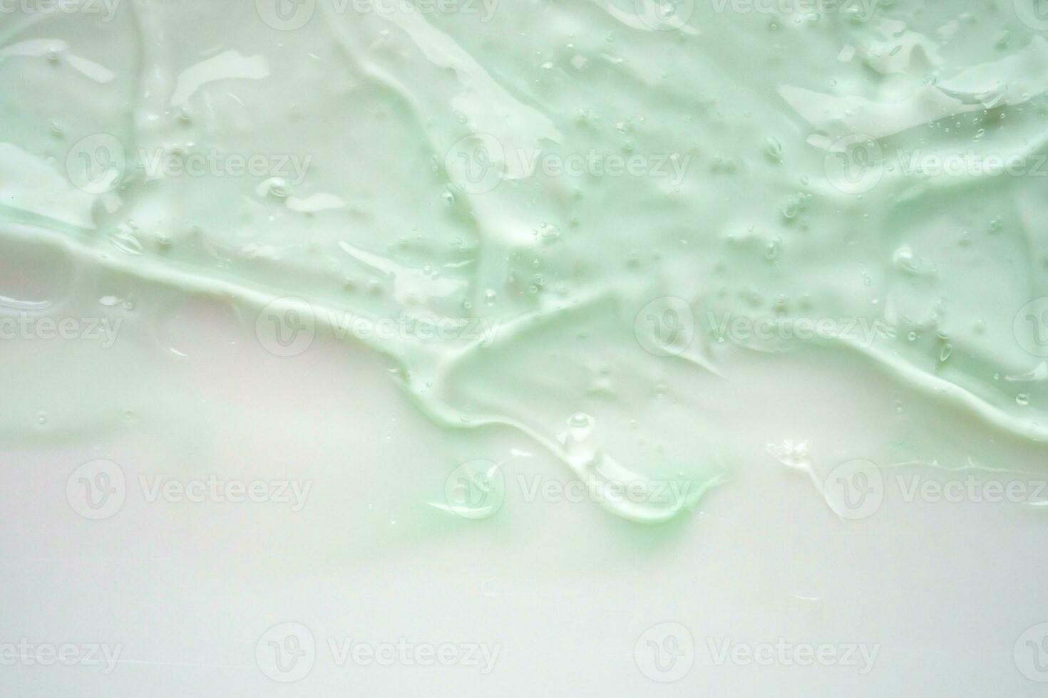 Transparent clear green liquid serum gel cosmetic texture background photo