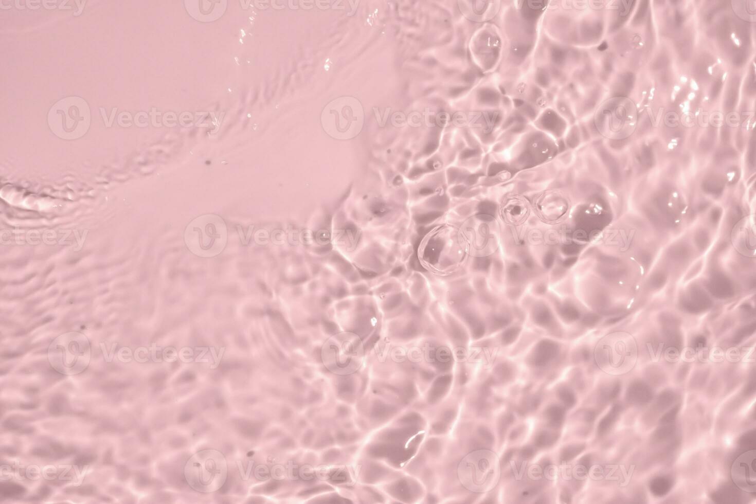 Abstract transparent water shadow surface texture natural ripple on pink background photo
