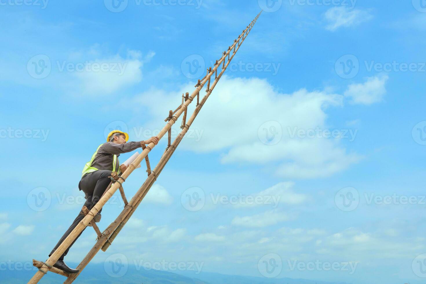 Asian business man engineer climbing up llong adder with blue sky, career growth and success concept photo