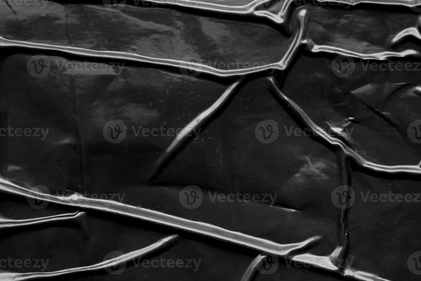 black crumpled and creased plastic poster texture background photo