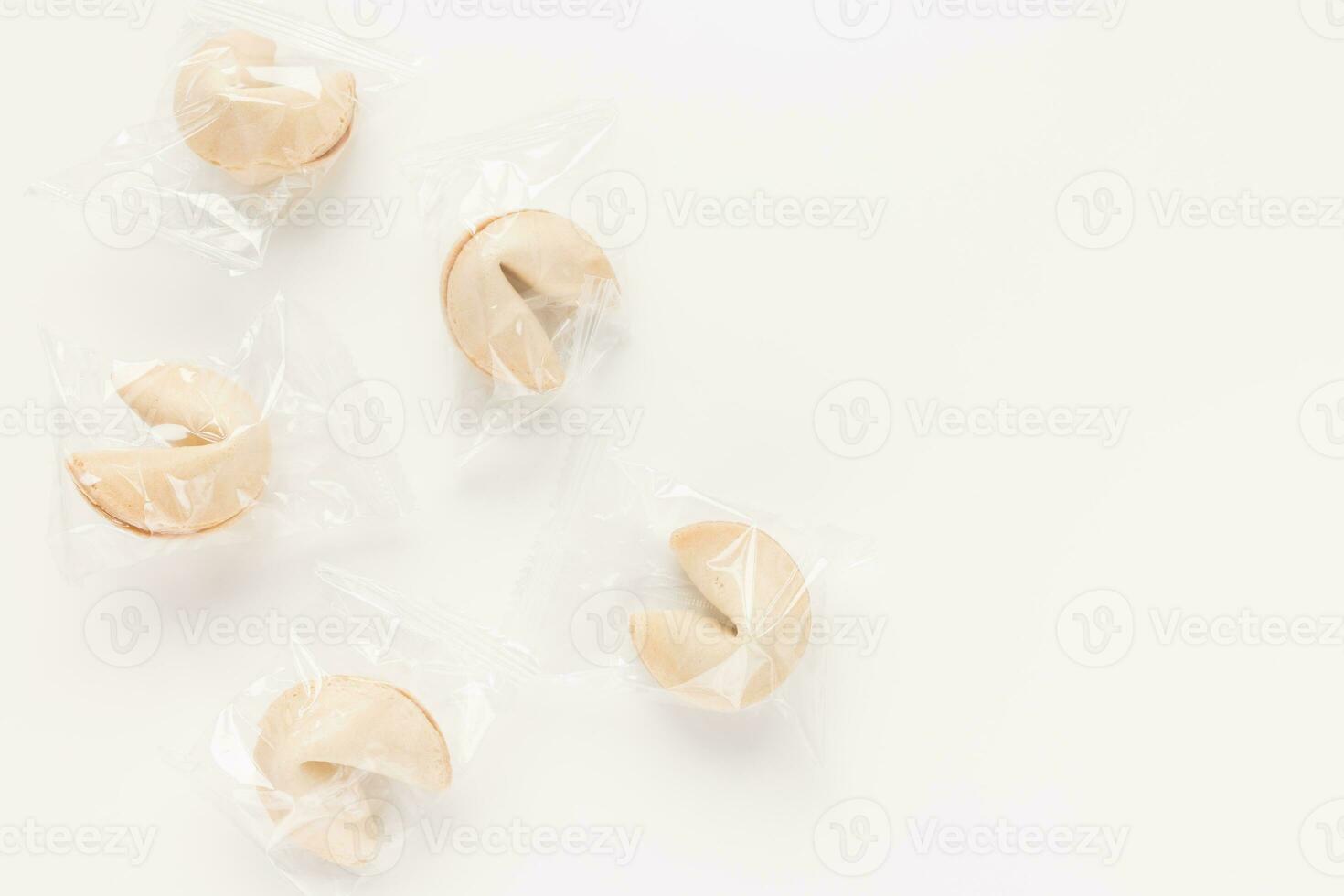 Fresh and tasty Chinese fortune cookies, individually wrapped in foil on white background. Top view, copy space photo