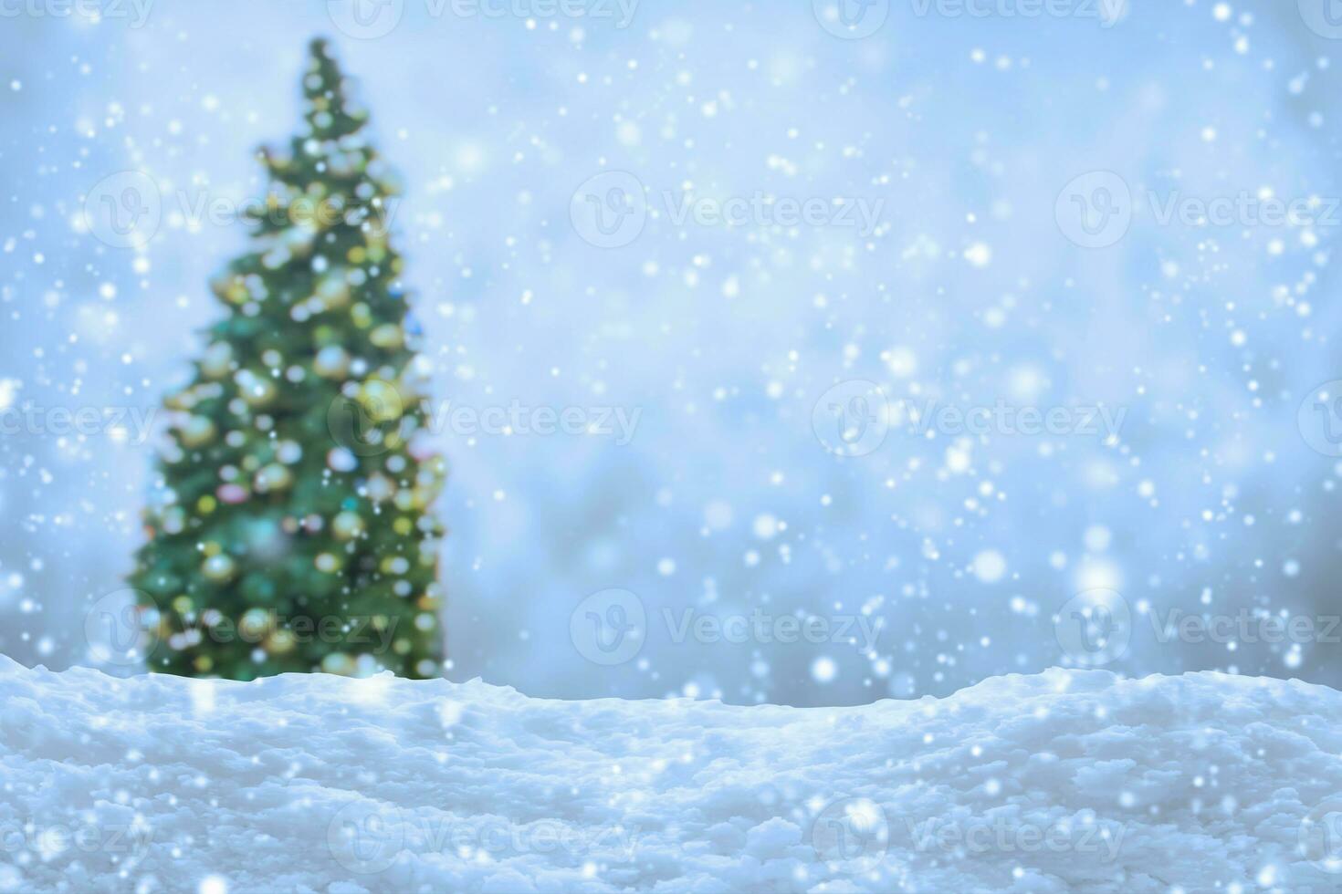 Empty white snow with blur Christmas tree with bokeh light background photo
