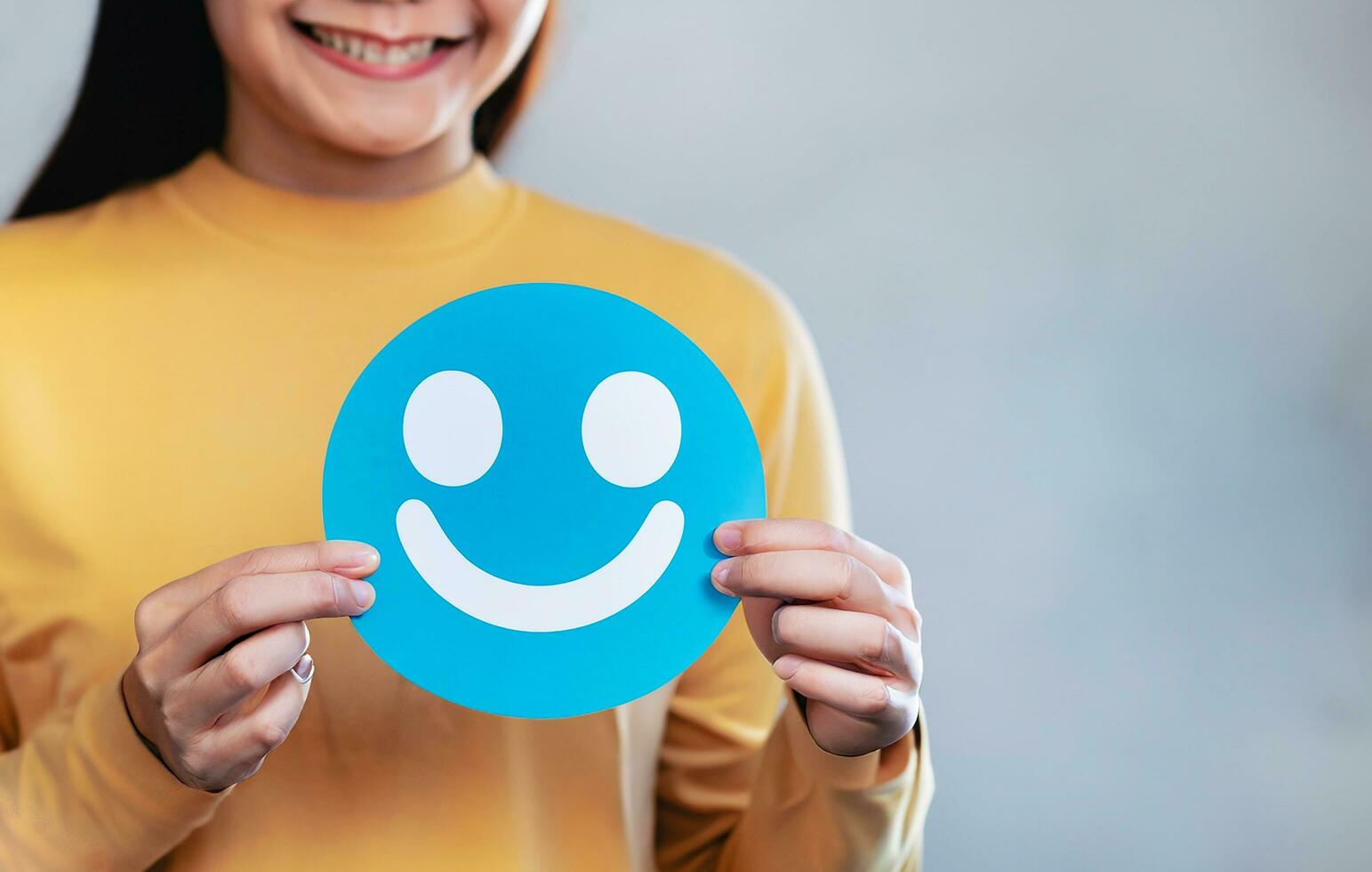 Woman holding blue paper cut happy smile face, positive, customer review, Compliment Day, mental health assessment,Compliment Day, world mental health day concept, satisfaction concept, AI Generative photo