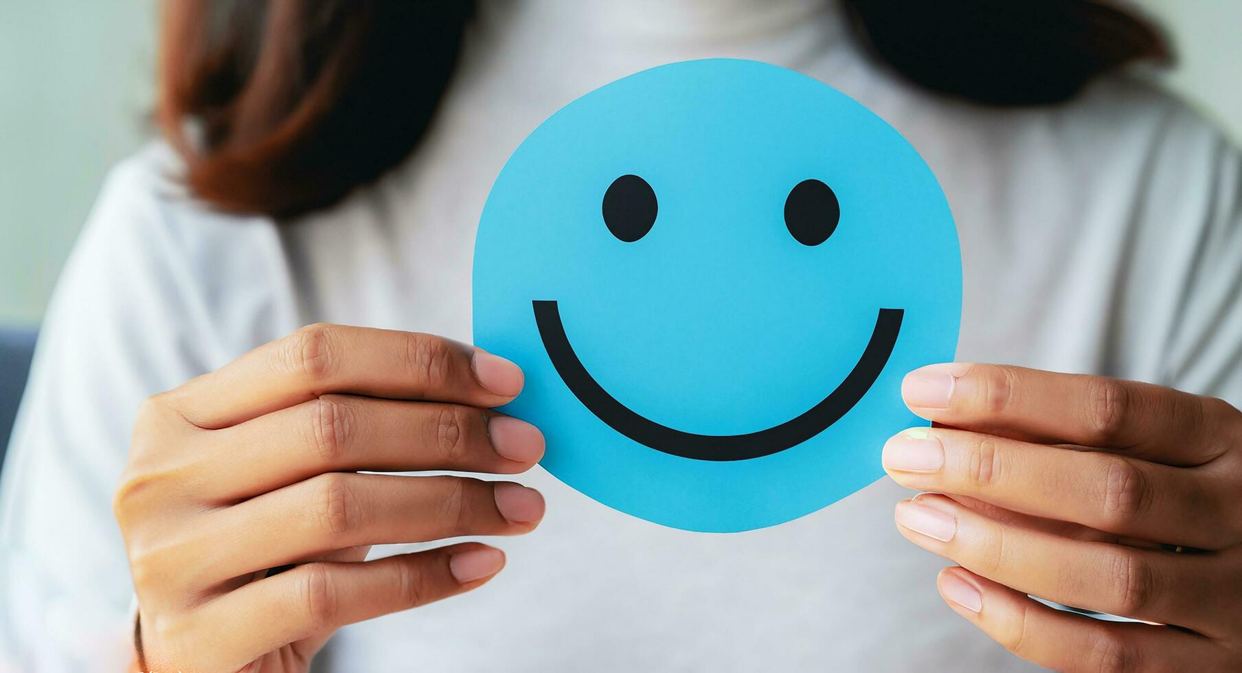 Woman holding blue paper cut happy smile face, positive, customer review, Compliment Day, mental health assessment,Compliment Day, world mental health day concept, satisfaction concept, AI Generative photo