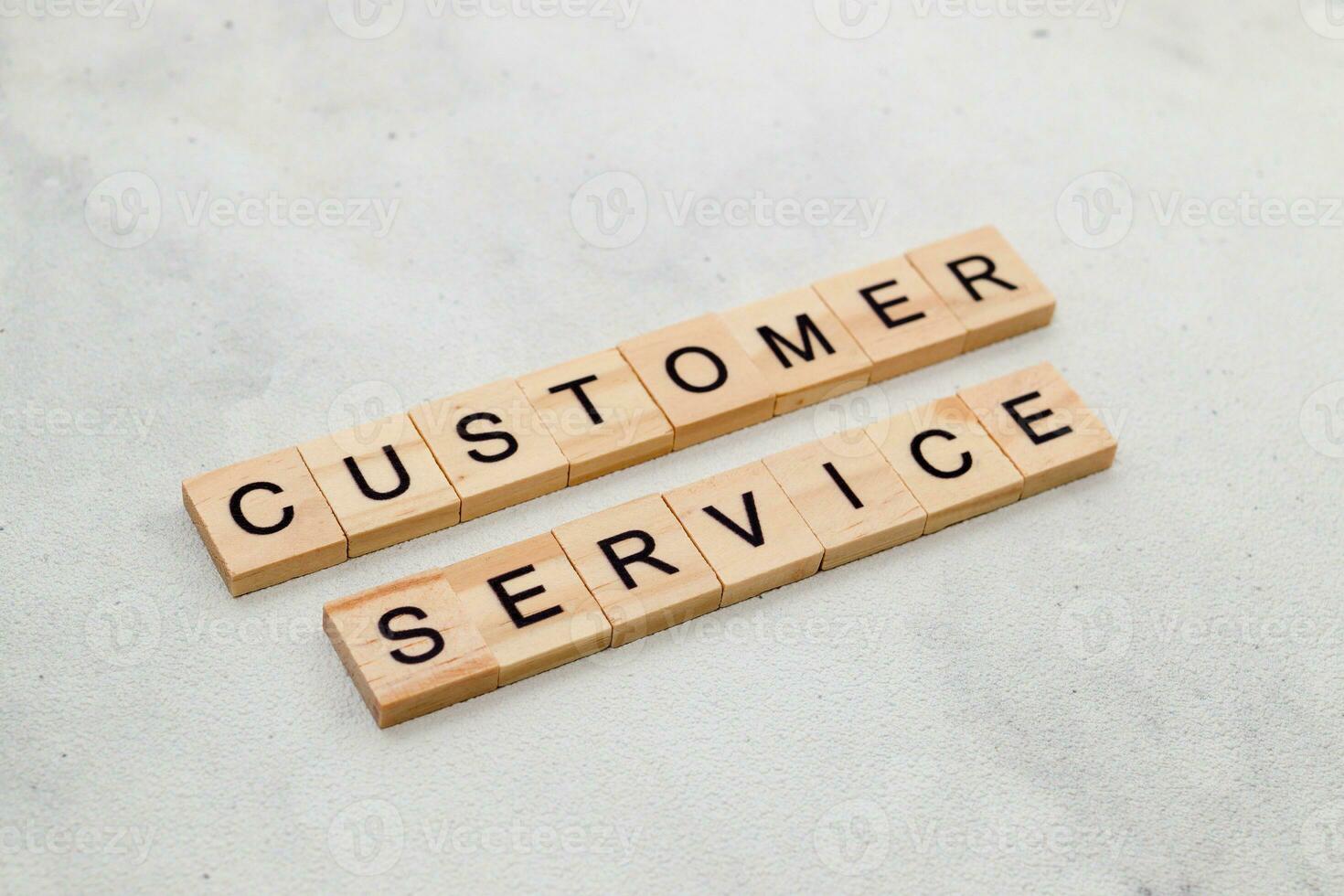 Top view of Customer Service word on wooden cube letter block on white background. Business concept photo