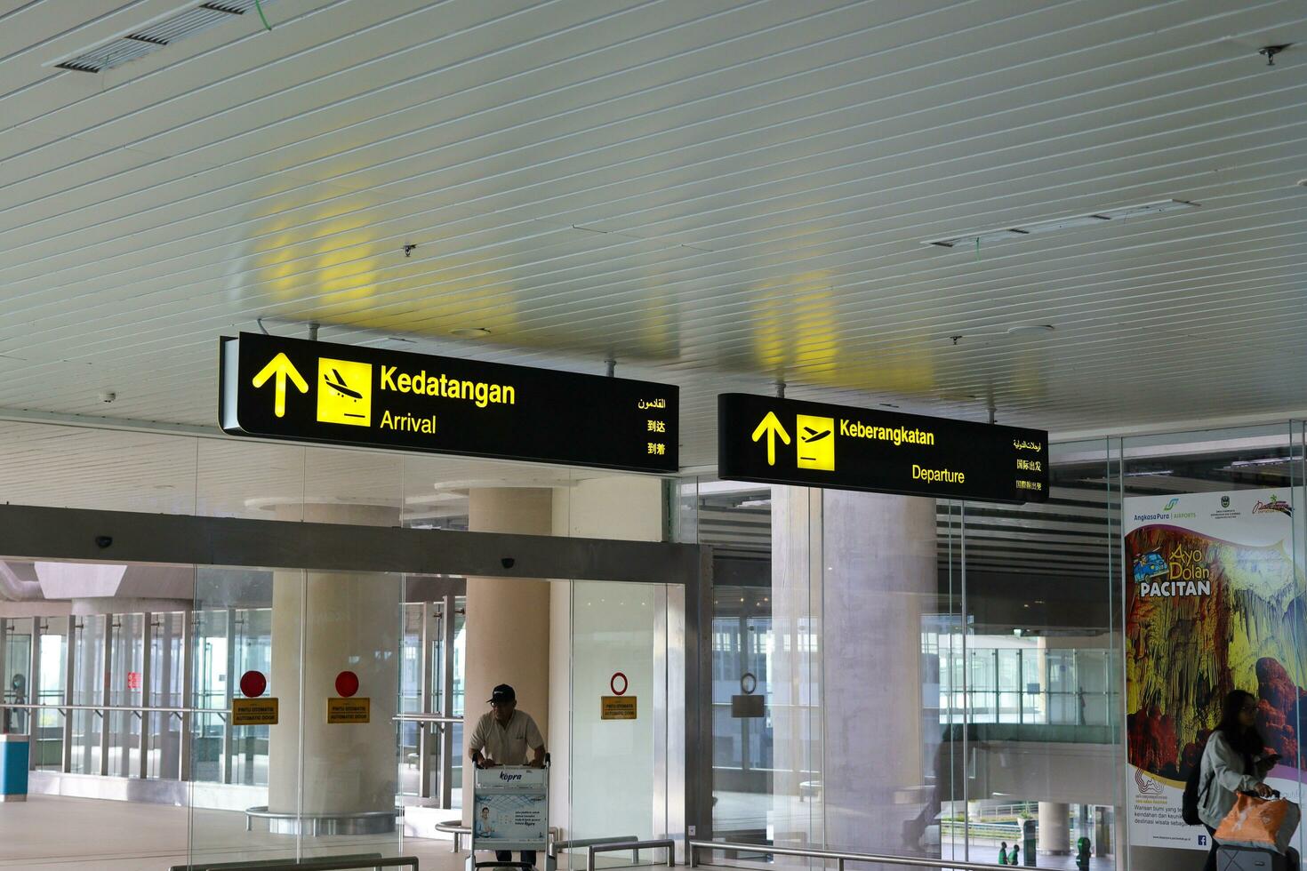 Directional sign at the airport as information for passengers. Yogyakarta International Airport YIA is modern facility serving international and domestic flights. Kulon Progo - Indonesia 09 03 2023 photo