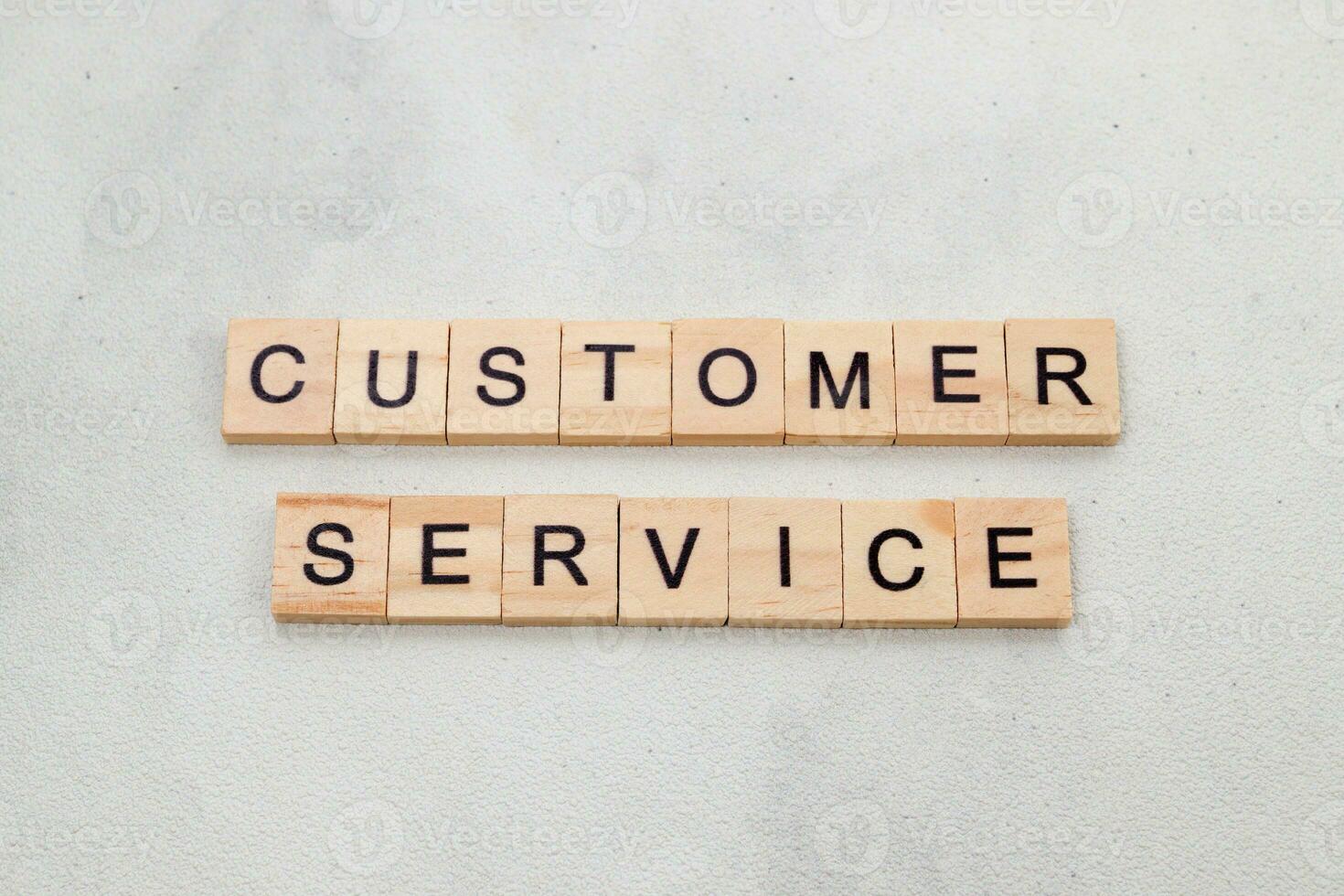 Top view of Customer Service word on wooden cube letter block on white background. Business concept photo