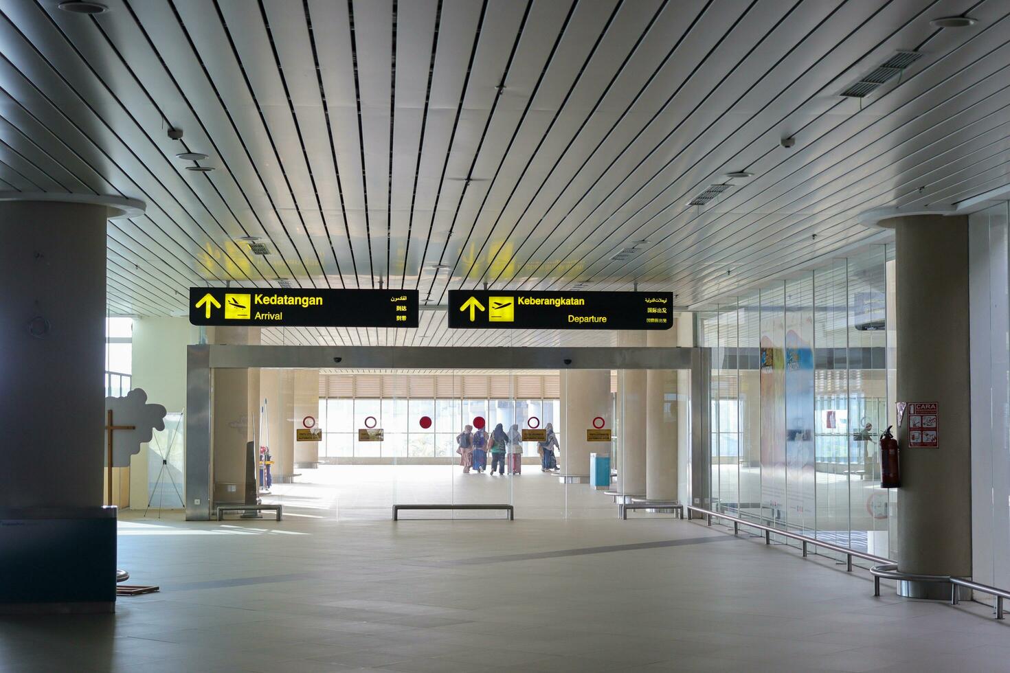 Directional sign at the airport as information for passengers. Yogyakarta International Airport YIA is modern facility serving international and domestic flights. Kulon Progo - Indonesia 09 03 2023 photo