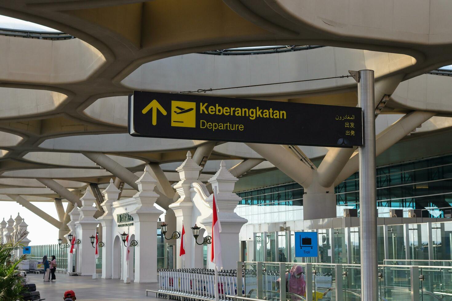 Directional sign at the airport as information for passengers. Yogyakarta International Airport YIA is modern facility serving international and domestic flights. Kulon Progo - Indonesia 09 03 2023 photo