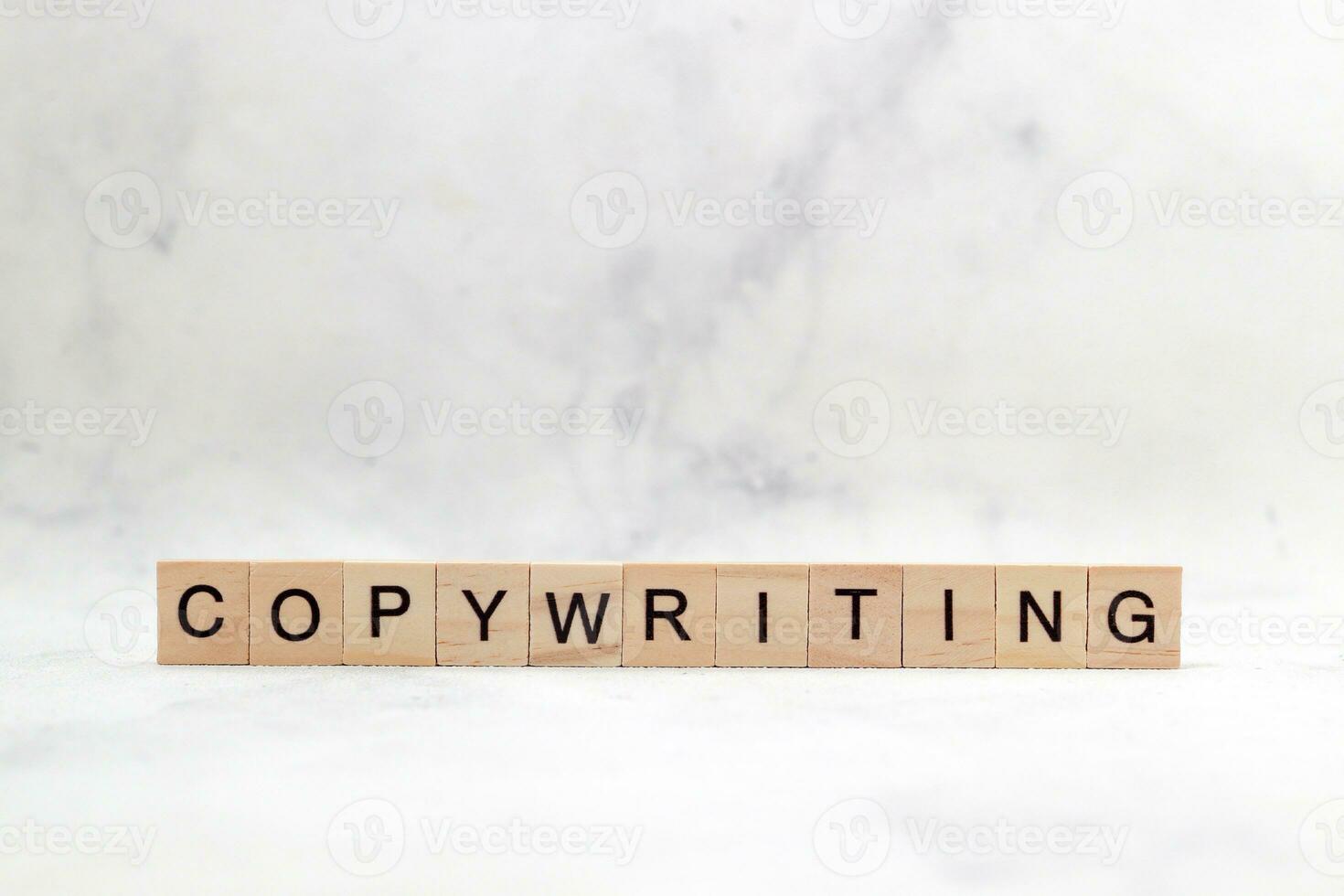 Top view of Copywriting word on wooden cube letter block on white background. Business concept photo