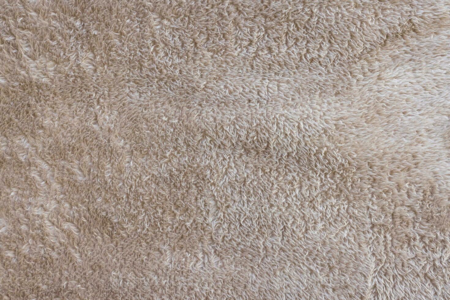 New soft brown throw blanket texture. Abstract fabric background. Top view, close up photo