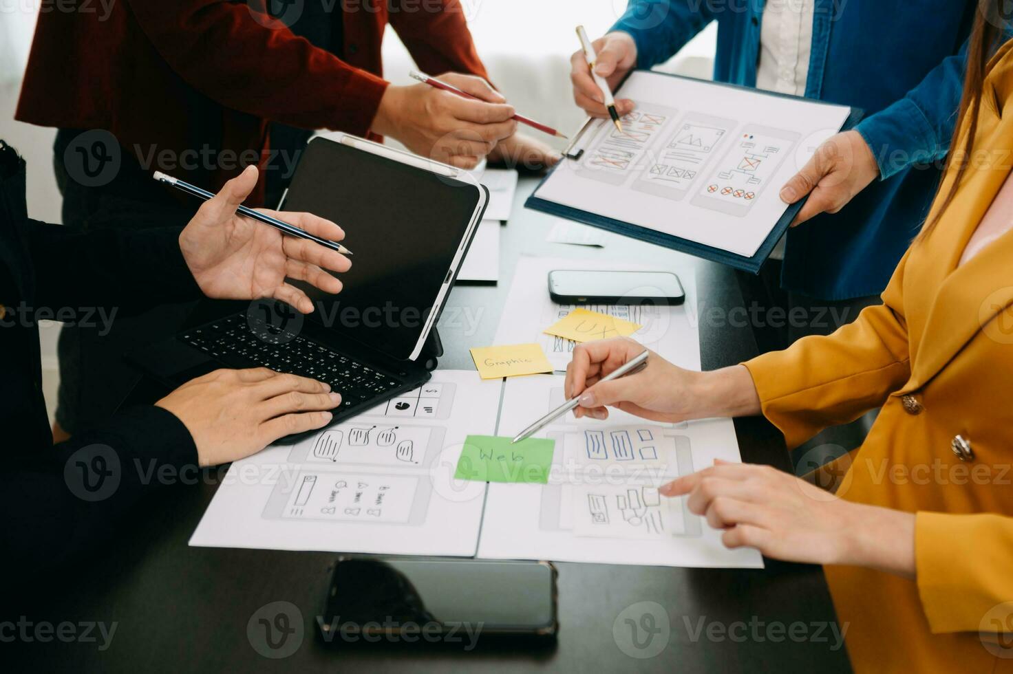 UX developer and ui designer brainstorming about mobile app interface wireframe design with customer breif and color code at modern office. photo
