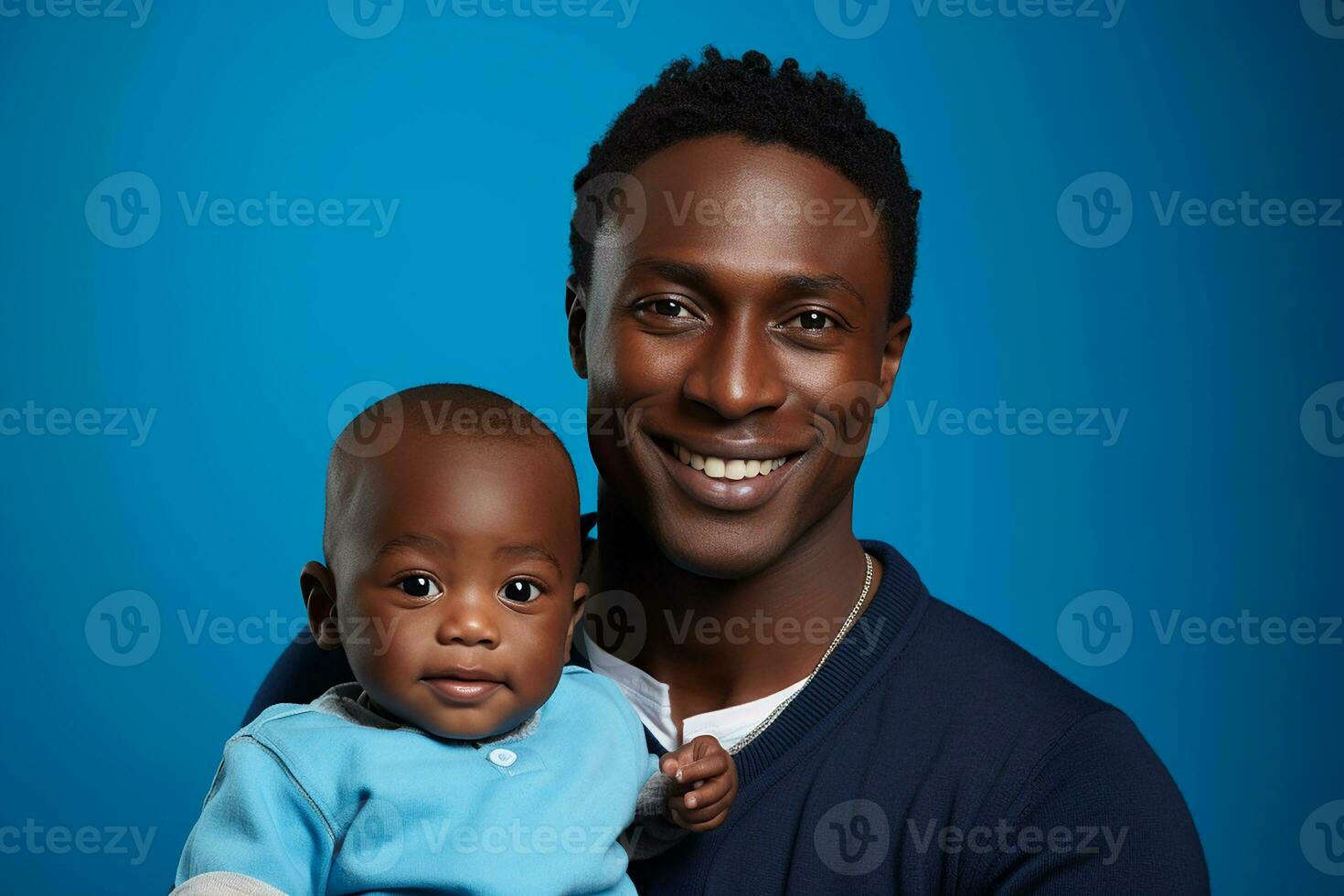 Studio portrait of handsome man holding infant baby in his hands on different colour background photo