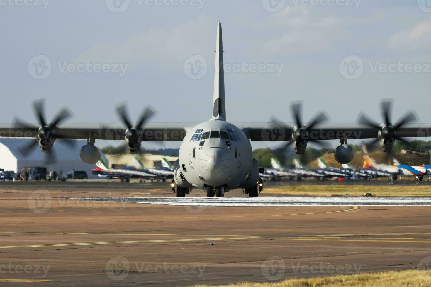 Untitled military transport plane at air base. Airport and airfield. Air force and army flight operation. Aviation and aircraft. Air lift. Military industry. Fly and flying. photo