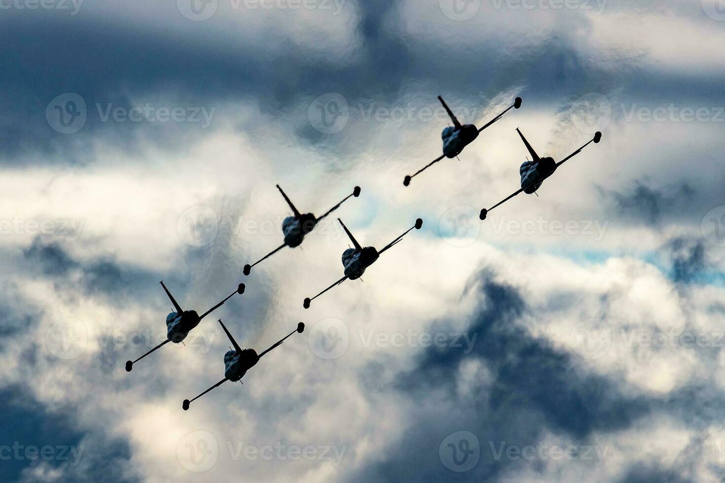 Aerobatic team at airshow. Flight demonstration and formation flying. Air force and military show. Airport and air base. Aviation and aircraft. Fly and flying. photo