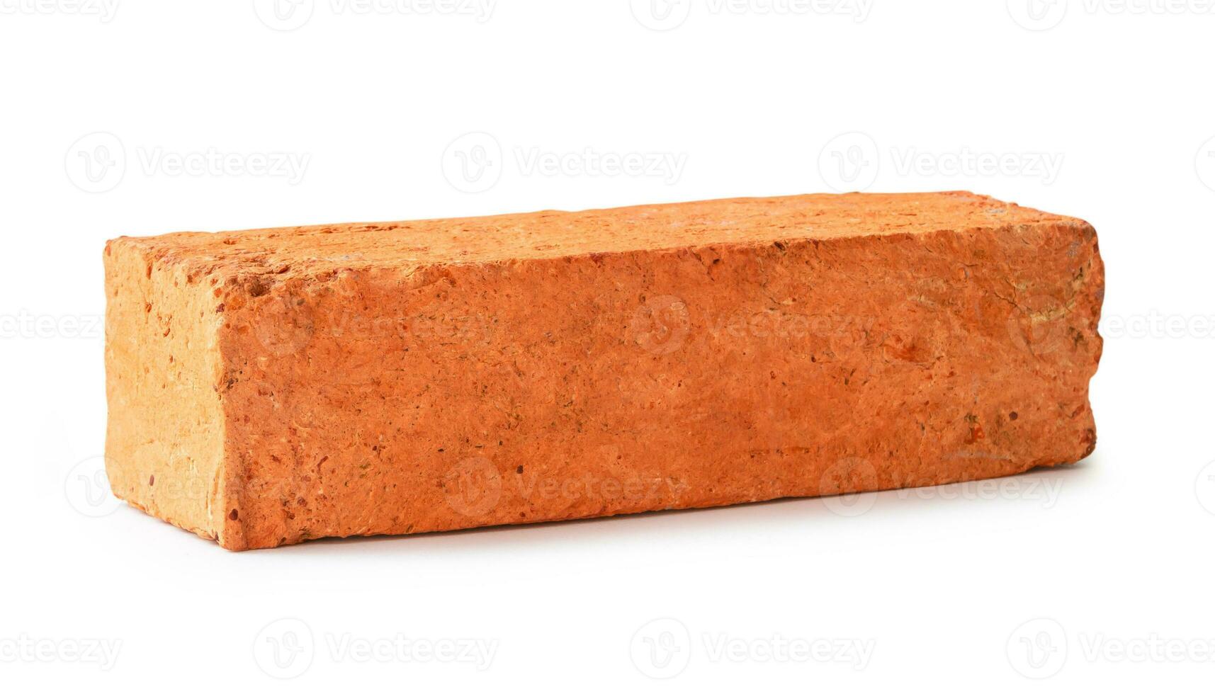 Single cracked old red or orange brick isolated on white background with clipping path photo