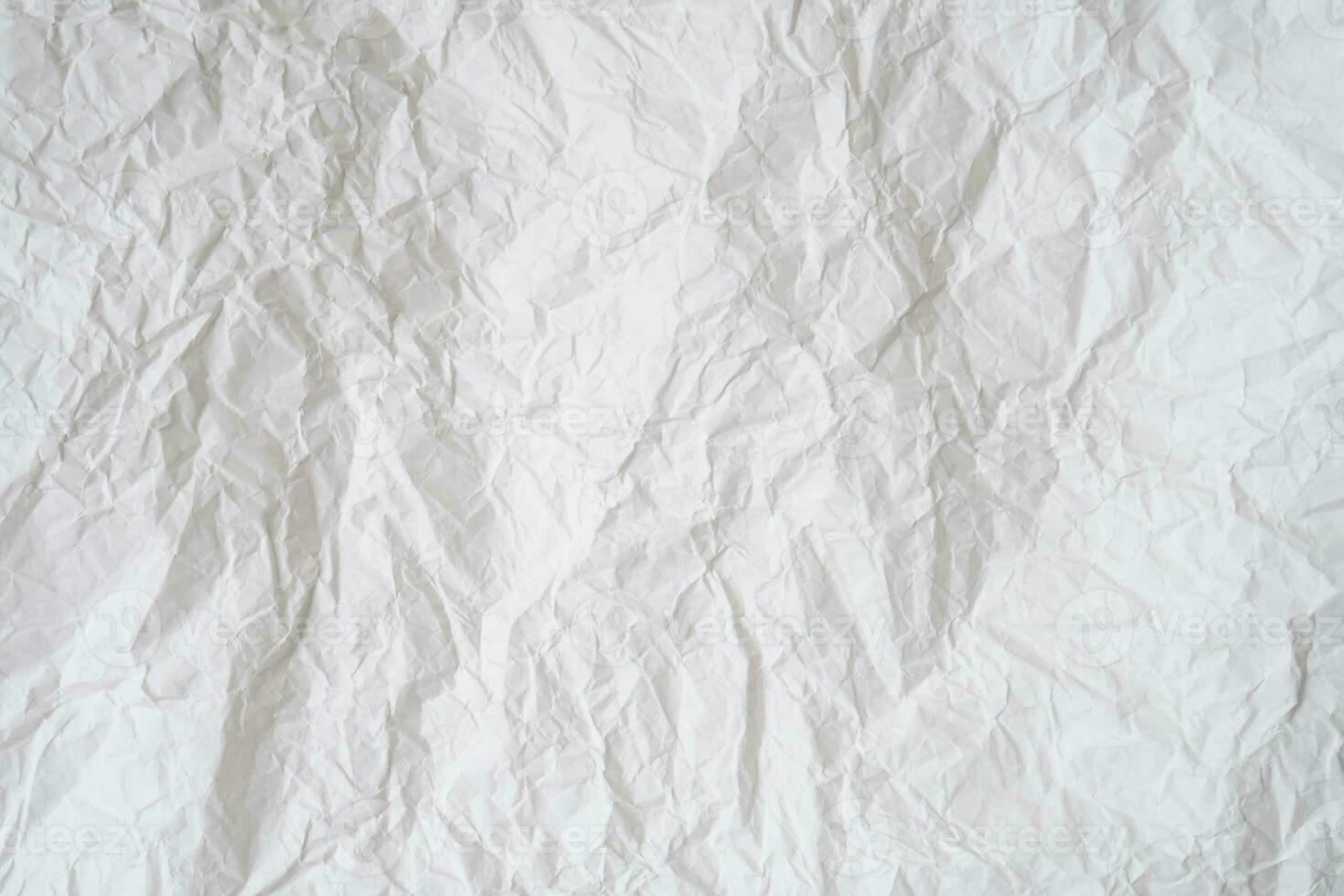 Wrinkled or crumpled white stencil paper or tissue after use in toilet or restroom with large copy space used for background texture in decorative art work photo