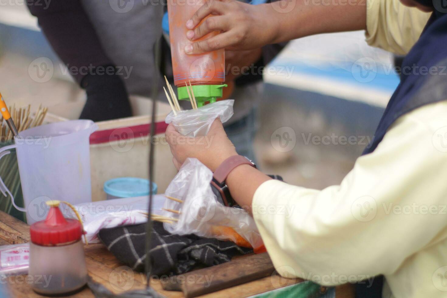 people  Indonesian  when buying snacks outside the home photo