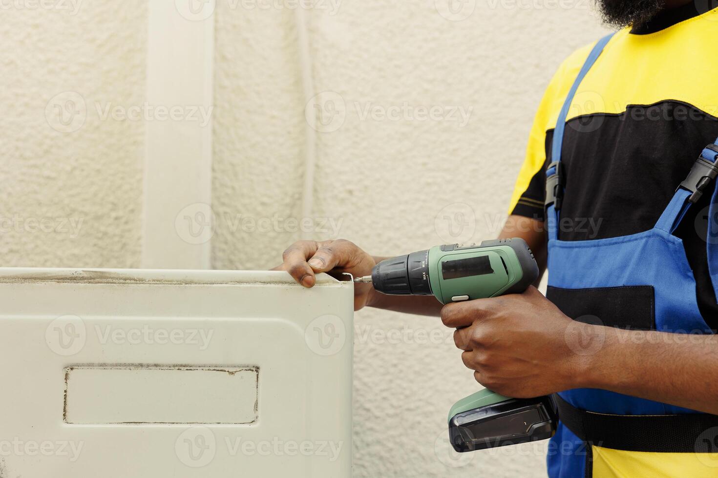 Trained professionals installing new outdoor air conditioner for home owner client after replacing old unit. Qualified technicians commissioned to optimize new HVAC system performance photo